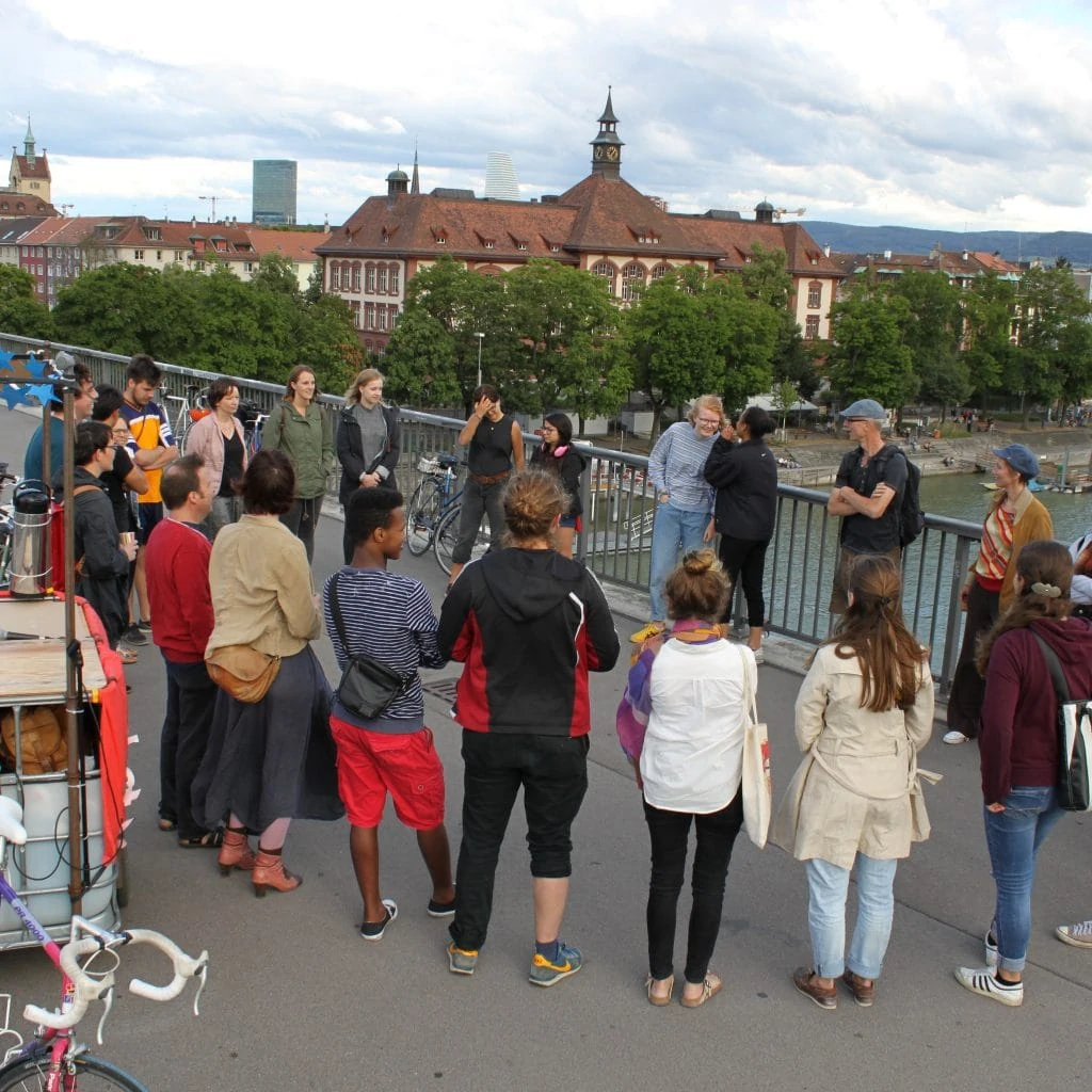 A circle of people on the Dreirosenbrücke.