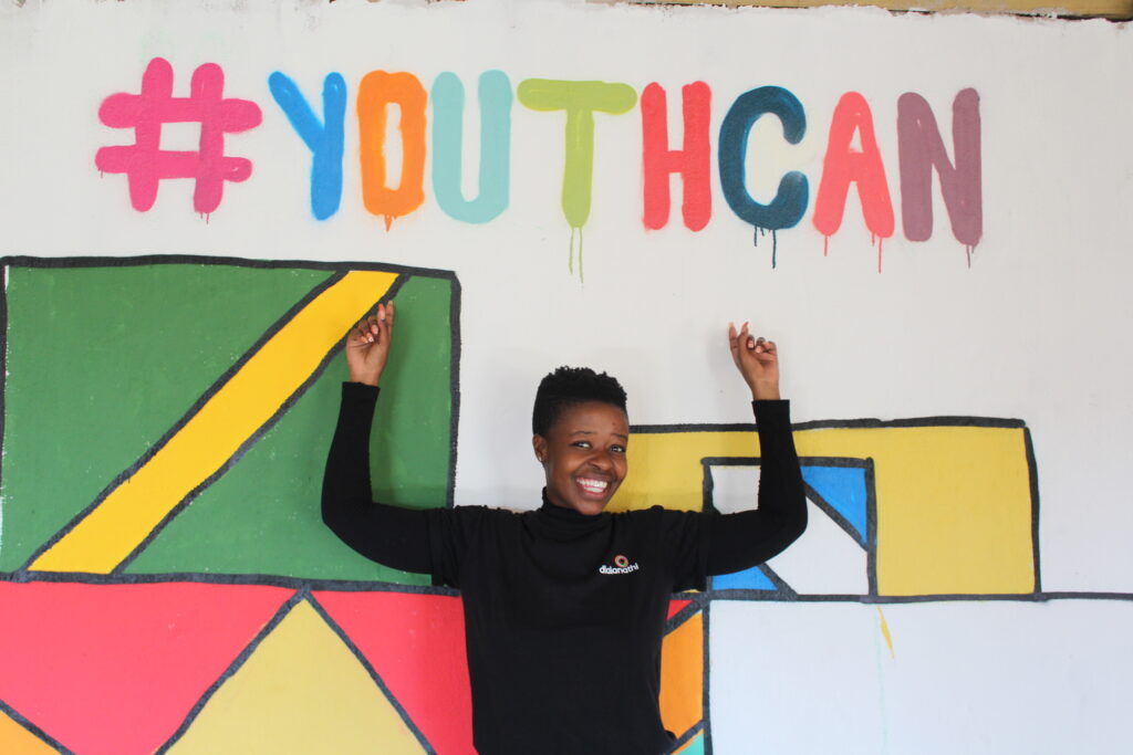young-woman-stands-for-a-graffity-wall-with-the-headline-youthcan